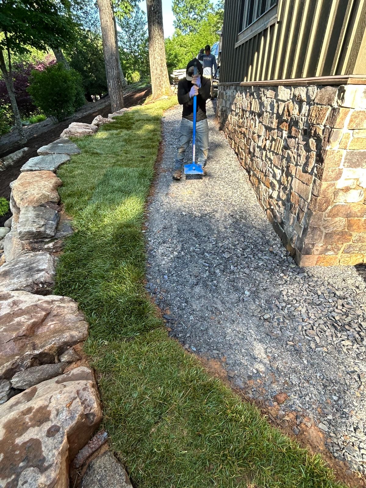 A finished gravel path with stone edging and a retaining wall beside a High Country home in Boone, NC