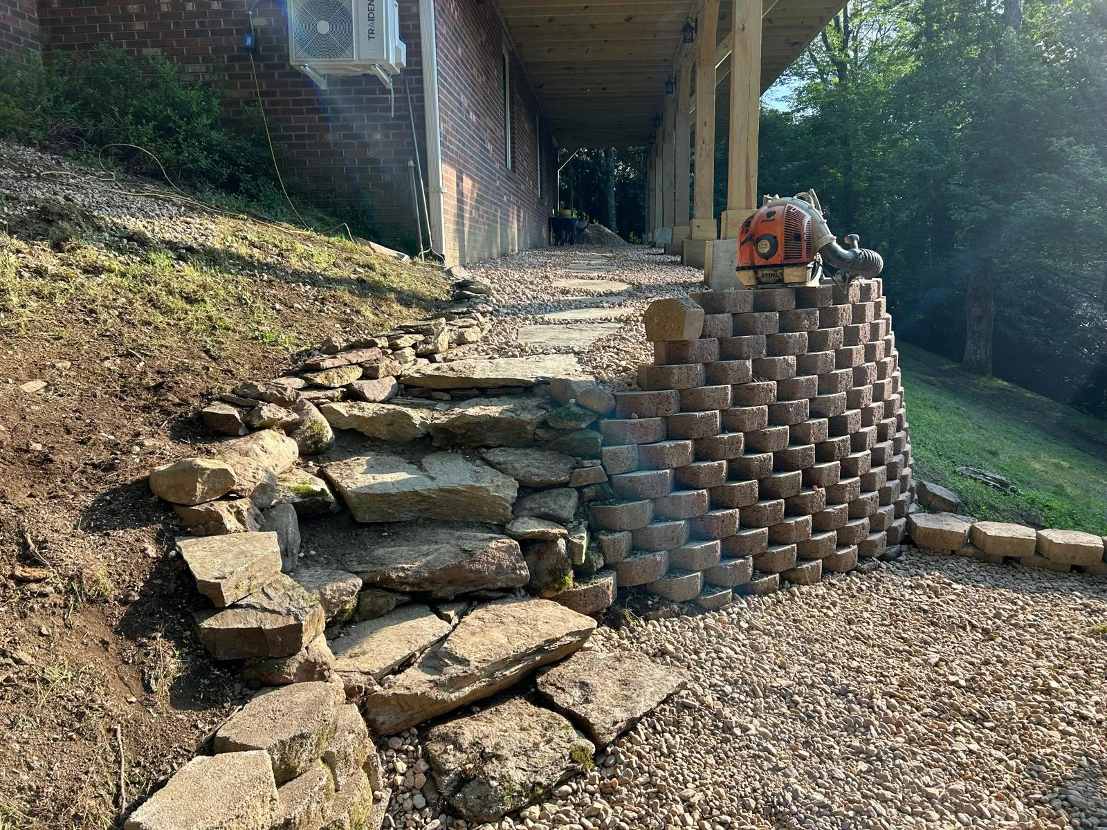 A tiered block retaining wall River Birch built on a steep slope in the High Country, NC